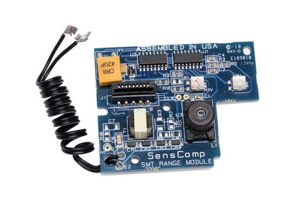 Rectangular blue SensComp ultrasonic range module circuit board with various electronic components, a coiled black wire, and visible text labels.