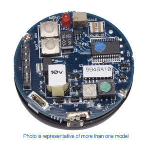 Zoomed view of round ultrasonic sensor circuit board with various components, including chips, capacitors, and labeled stickers, shown close-up on a white background.