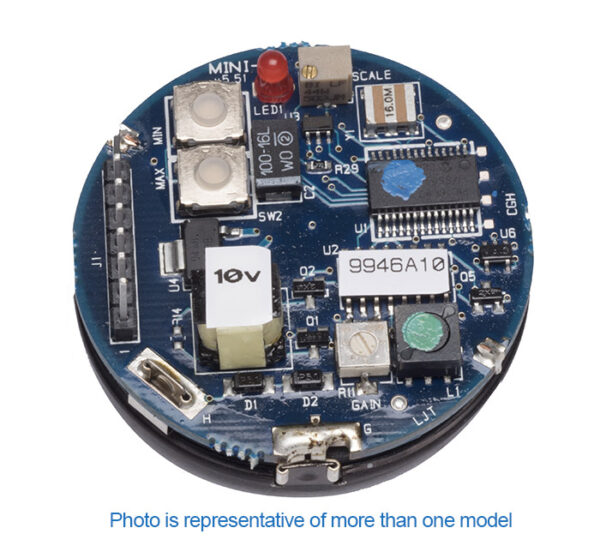 Zoomed view of round ultrasonic sensor circuit board with various components, including chips, capacitors, and labeled stickers, shown close-up on a white background.
