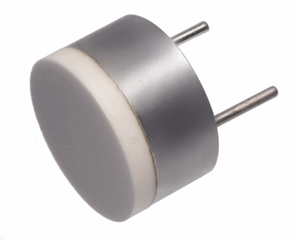 Small, round ultrasonic transducer with metallic housing and white ceramic front surface, shown isolated on white background.