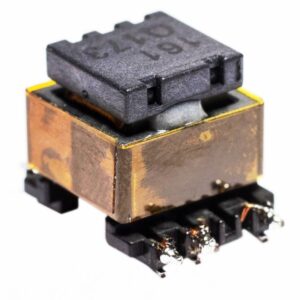 Rectangular electronic transformer with metallic copper-colored casing, black plastic top, and soldered surface-mount connections, shown angled on a white background.