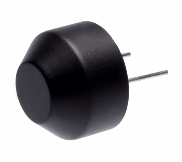 Black plastic ultrasonic sensor with domed front surface and two metal pin leads extending from the back, shown angled on white background.