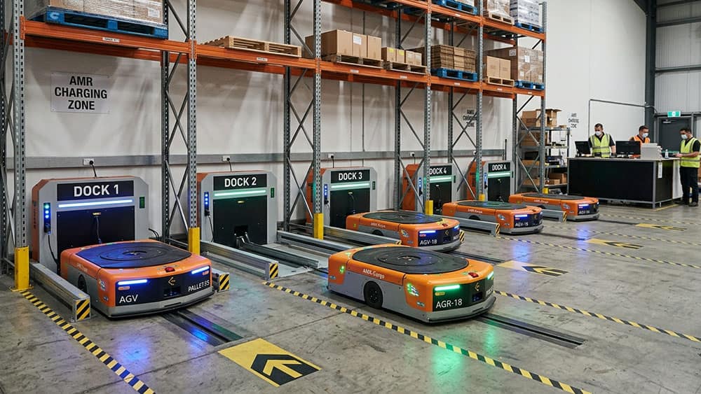 Automated guided vehicles parked at numbered charging docks, a close-range electrostatic ultrasonic sensing task.