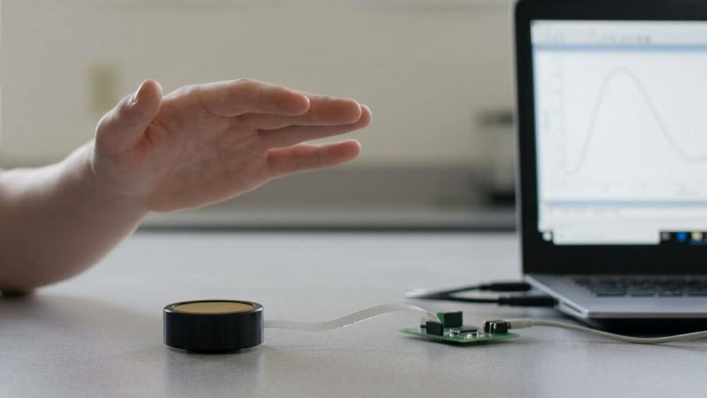 Electrostatic ultrasonic transducer measuring a wooden target a few inches away on a laboratory bench